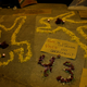 Cempasuchil marigold petals form human-shaped outlines on the ground beside lit candles and a placard during an event held in remembrance of the 43 missing student teachers from the Ayotzinapa Teacher Training College Raul Isidro Burgosin, in Iguala